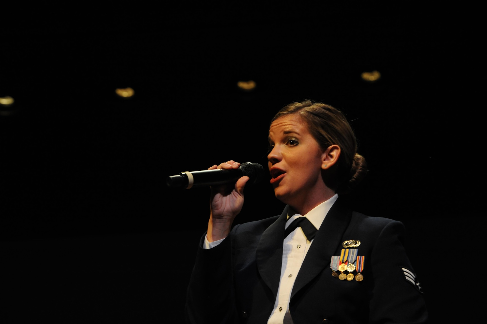 Senior Airman Melissa Lackore, U.S. Air Force Heritage of America Band vocalist, sings “At Last” during a USAF HOAB 75th Anniversary Band Concert at the Ferguson Center for the Arts in Newport News, Va., Oct. 1, 2016. Prior to joining the Air Force, SrA Lackore taught K-12 vocal music in the Iowa public school system, as well as, High School vocal, instrumental music and music theory in Nebraska Catholic schools. (U.S. Air Force photo by Staff Sgt. Nick Wilson)