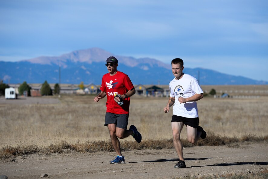 Shawn Brennan, Space and Missile Systems Center, and Christopher Anderson, 50th Civil Engineer Squadron, race to the finish line during the 11th annual Half Marathon at Schriever Air Force Base, Colorado, Friday, Oct. 14, 2016. Anderson just edged Brennan for second-place, finishing only 1-second ahead. (U.S. Air Force photo/Christopher DeWitt)