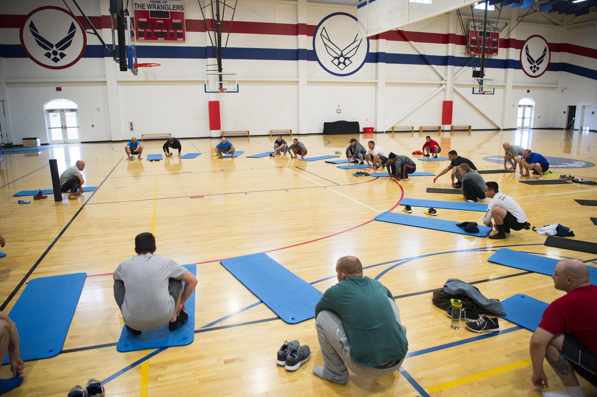 Base personnel perform a squat stretch during a natural running form clinic at F.E. Warren Air Force Base, Wyo., Oct. 6, 2016. More than 50 people signed up for this one-day course, to improve their running. “I brought this course here to help Airmen improve their run times and decrease risk of injury during their physical training test.” said Alison Morrell, 90th Medical Operations Squadron health promotion coordinator. “I think it’s important to understand a well-rounded fitness program for overall health and longevity.” (U.S. Air Force photo by Staff Sgt. Christopher Ruano)
