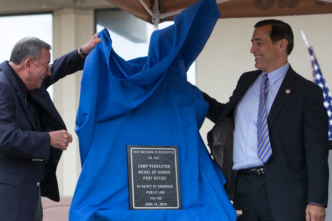 U.S. Marine Corps Medal of Honor recipient Col. Jay Vargas (retired), left, and the honorable Darrell E. Issa, congressman, 49th Congressional District, unveil the plaque to commemorate the Medal of Honor post office dedication ceremony on Camp Pendleton, Calif., Oct. 17, 2016. (U.S.Marine Corps photo by Cpl. Brian Bekkala)