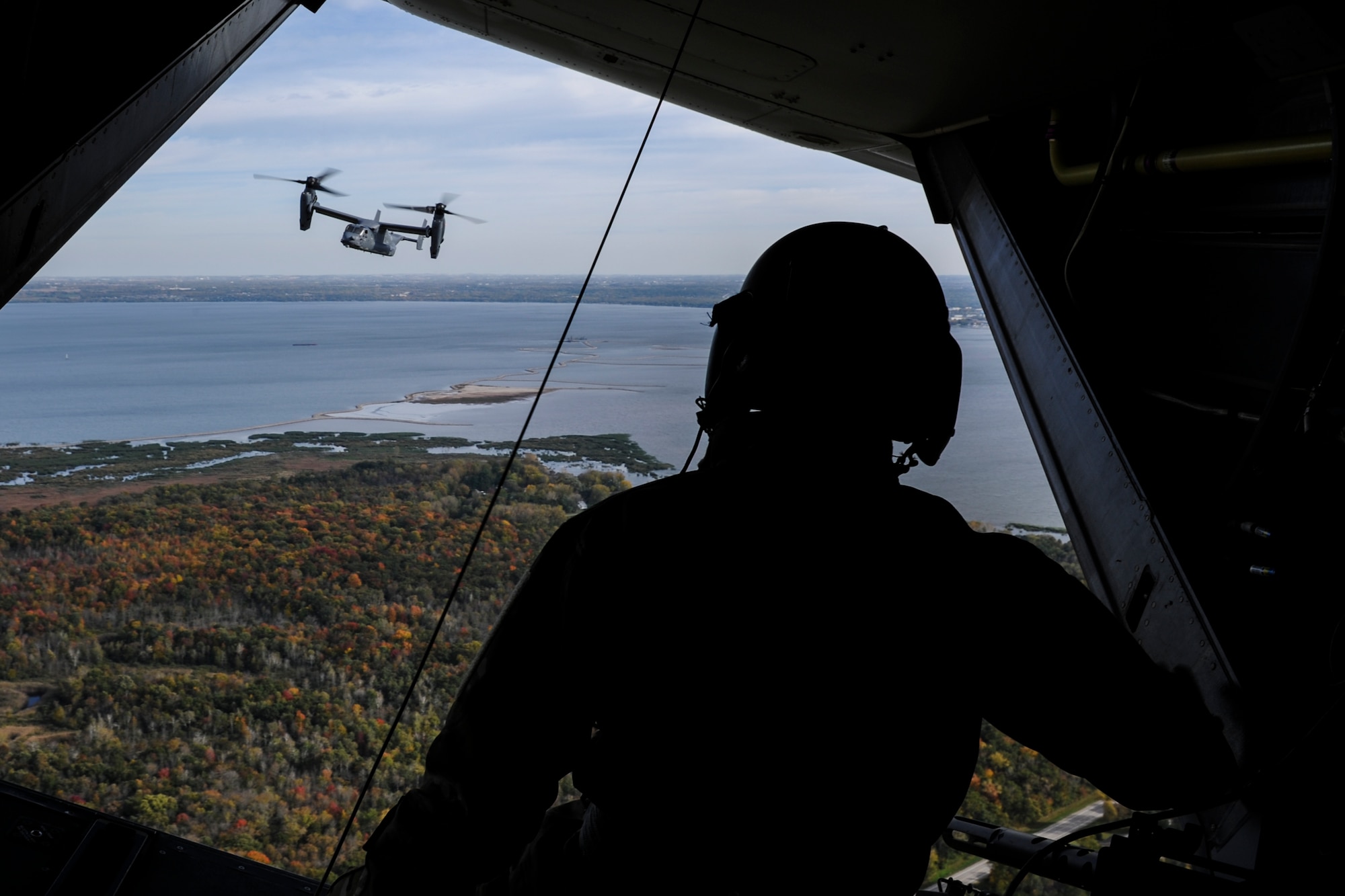 Staff Sgt. Dustin Trevino, a flight engineer with the 8th Special Operations Squadron, looks at a CV-22 Osprey tiltrotor aircraft over Green Bay, Wis., Oct. 14, 2016. The 8th SOS visited the Milwaukee-Green Bay area for a flyover above Lambeau Field Oct. 16 during the Green Bay versus Dallas NFL game. The Osprey offers increased speed and range over other rotary-wing aircraft, enabling Air Force Special Operations Command aircrews to execute long-range special operations missions. (U.S. Air Force photo by Airman 1st Class Joseph Pick)
