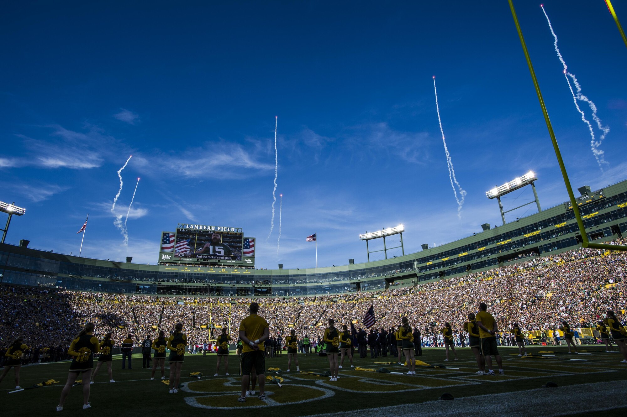 Players and fans stand for the national anthem at Lambeau Field, Wis., Oct. 16, 2016. Moments later, four CV-22 Osprey aircraft with the 8th Special Operations Squadron from Hurlburt Field flew above the stadium. The Osprey is a tiltrotor aircraft that combines the vertical takeoff, hover and vertical landing qualities of a helicopter with the long-range, fuel efficiency and speed characteristics of a turboprop aircraft. (U.S. Air Force photo by Airman 1st Class Joseph Pick)