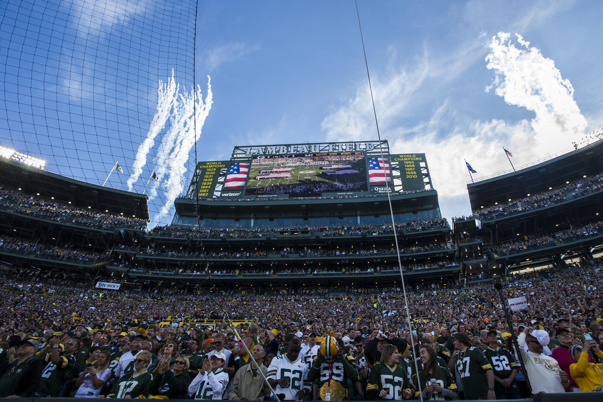 Fans celebrate following a flyover of four CV-22 Osprey aircraft at Lambeau Field, Wis., Oct. 16, 2016. During the final moments of the national anthem, Ospreys with the 8th Special Operations Squadron from Hurlburt Field flew over the stadium. The Osprey offers increased speed and range over other rotary-wing aircraft, enabling Air Force Special Operations Command aircrews to execute long-range special operations missions. (U.S. Air Force photo by Airman 1st Class Joseph Pick)