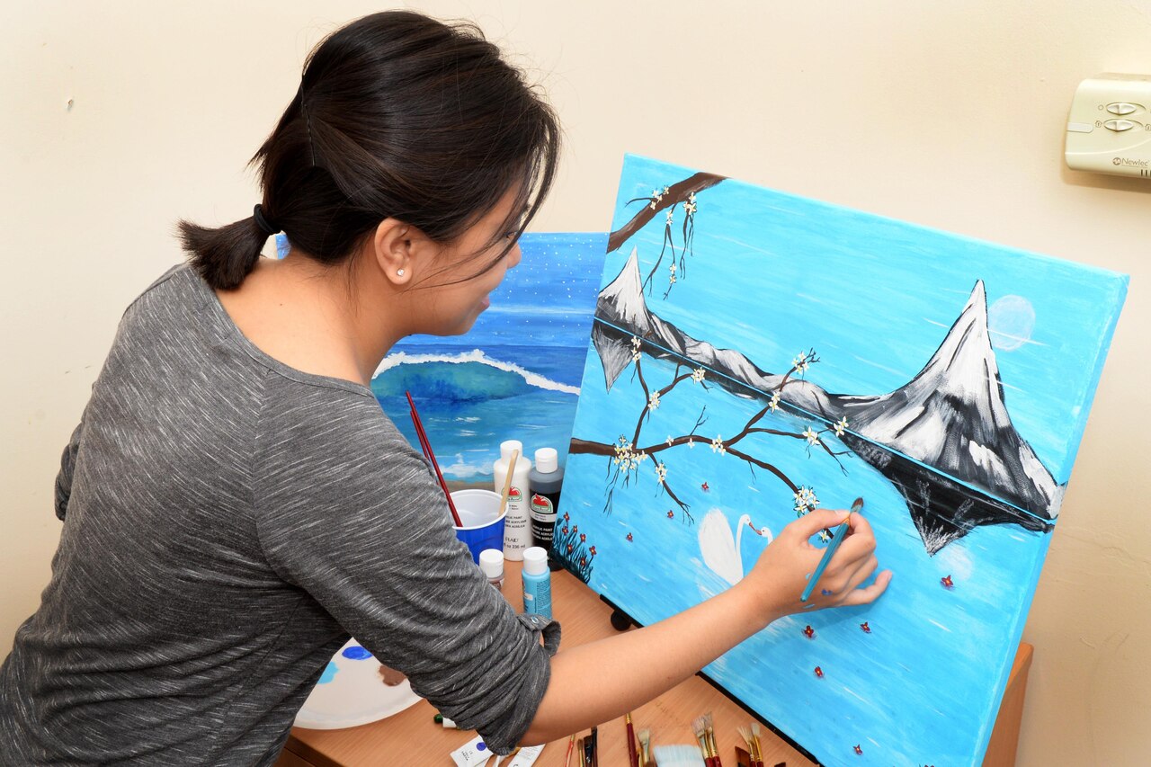 U.S. Air Force Senior Airman Regine Labarda, 100th Comptroller Squadron relocation technician, paints a landscape scene Oct. 17, 2016, in England. Labarda uses her love of painting to make the most of her down time. (U.S. Air Force photo by Airman 1st Class Tenley Long)