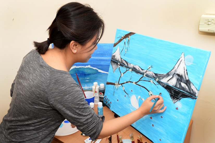 U.S. Air Force Senior Airman Regine Labarda, 100th Comptroller Squadron relocation technician, paints a landscape scene Oct. 17, 2016, in England. Labarda uses her love of painting to make the most of her down time. (U.S. Air Force photo by Airman 1st Class Tenley Long)