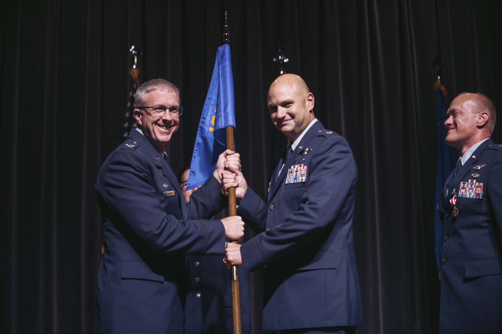 Col. Robert Kilgore, 107th Airlift Wing commander, Niagara Falls Air Reserve Station, N.Y., hands over the guidon of the 107th Operations Squadron here to Lt. Col. Douglas Euote during a ceremony marking the change of command for the squadron, Sept. 27, 2016. Euote takes command of the 107th OS from Lt. Col. Gary Charlton who was selected to be vice commander of the 107th AW. (Air National Guard photo by Staff Sgt. Ryan Campbell)