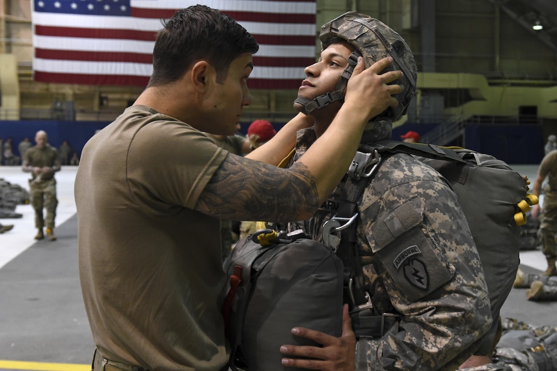 A paratrooper checks the rigging of a fellow paratrooper before a jump during Red Flag Alaska 17-1 at Joint Base Elmendorf-Richardson, Alaska, Oct. 12, 2016. About 2,095  service members will participate in the exercise. Air Force photo by Airman 1st Class Valerie Monroy