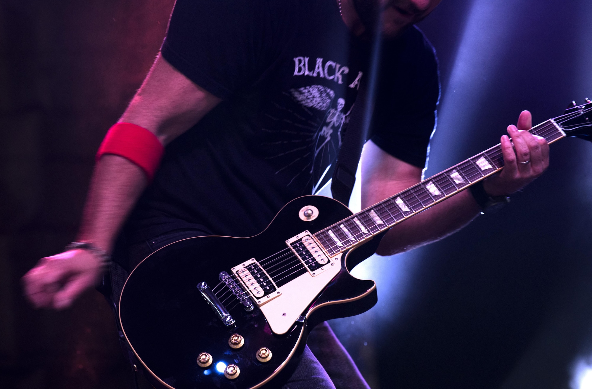 A member of the American rock band, 3 Doors Down, plays a guitar during a concert inside Hangar 1 at Spangdahlem Air Base, Germany, Oct. 16, 2016. The show was a part of the Armed Forces Entertainment tour, an Air Force command operation, which brings entertainment to U.S. military personnel serving overseas. (U.S. Air Force photo by Airman 1st Class Preston Cherry)
