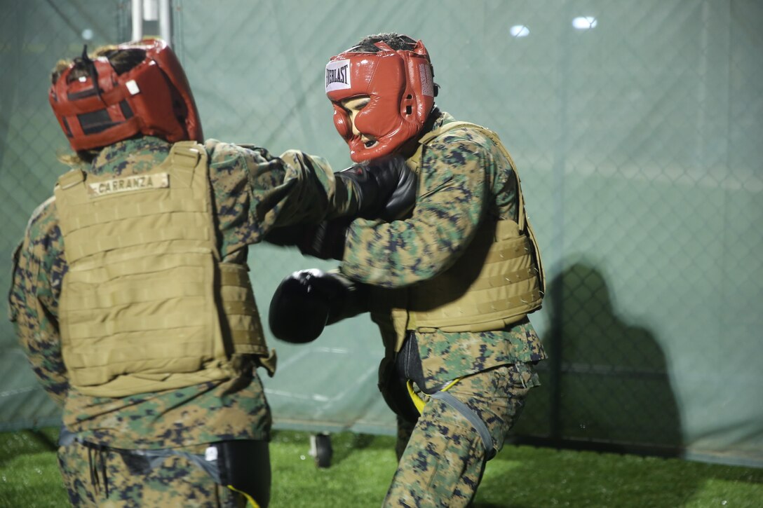 Cpl. Naylei Carranza, a supply clerk with Special Purpose Marine Air-Ground Task Force Crisis Response-Africa, lands a devastating lead hand punch during a sparring bout at Naval Air Station Sigonella, Italy, Sept. 30, 2016.  Marines with SPMAGTF-CR-AF completed a three-week long brown belt course for the Marine Corps Martial Arts Program.  (U.S. Marine Corps photo by 1st Lt. Eric Abrams/released)
