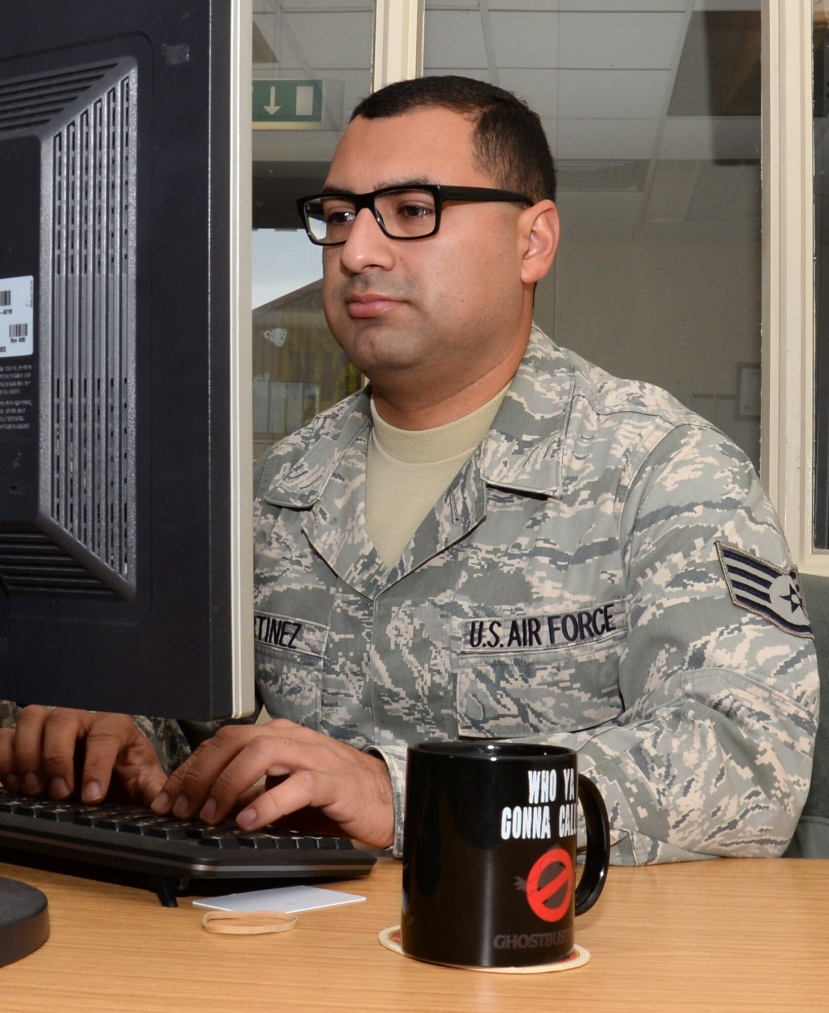 U.S. Air Force Staff Sgt. Jose Martinez, 100th Air Refueling Wing NCO in charge of inspections and analysis, checks a report about a minor accident Oct. 12, 2016, on RAF Mildenhall, England. There are around 300 Airmen across the Air Force dedicated to improving the safety of their wingmen. (U.S. Air Force photo by Gina Randall)