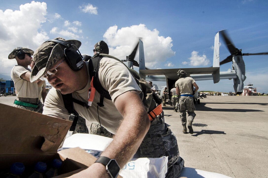 Air Force Staff Sgt. Justin Sprouse loads supplies onto a V22 Osprey in Port-au-Prince, Haiti, Oct. 17, 2016, to deliver to areas affected by Hurricane Matthew. Sprouse is assigned to the 621st Contingency Response Wing and attached to Joint Task Force Matthew, the U.S. Southern Command-directed team that includes Marines, soldiers, sailors and airmen. The team is providing airlift capabilities during the initial stages of the U.S. Agency for International Development's disaster relief operations in Haiti while the international response builds. Air Force photo by Staff Sgt. Robert Waggoner

