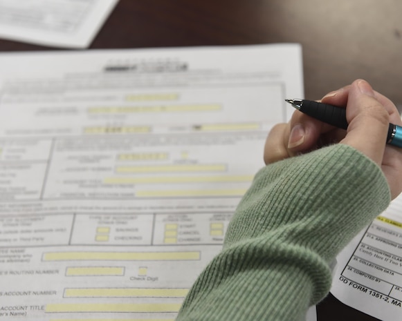 Megan Doty (left), 628th Security Forces Squadron unit program coordinator, files out her travel voucher with Senior Airman James Hauck, 628th Comptroller Squadron financial technician, in the Emergency Family Assistance Center at the Airman and Family Readiness Center on Joint Base Charleston Oct. 13. Besides financial assistance the EFAC provides chaplain assistance, legal aid, mental health support and military and family support.
