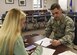 Megan Doty (left), 628th Security Forces Squadron unit program coordinator, files out her travel voucher with Senior Airman James Hauck, 628th Comptroller Squadron financial technician, in the Emergency Family Assistance Center at the Airman and Family Readiness Center on Joint Base Charleston Oct. 13. Besides financial assistance the EFAC provides chaplain assistance, legal aid, mental health support and military and family support.