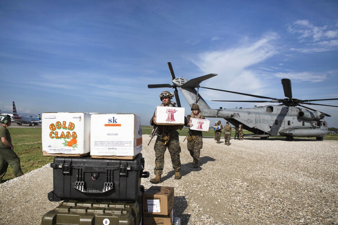 Marines unload humanitarian supplies and equipment from a CH- 53 Super Stallion helicopter in Port-au-Prince, Haiti, Oct. 17, 2016. The Marines are assigned to 24th Marine Expeditionary Unit. Marine Corps photo by Cpl. Brianna Gaudi