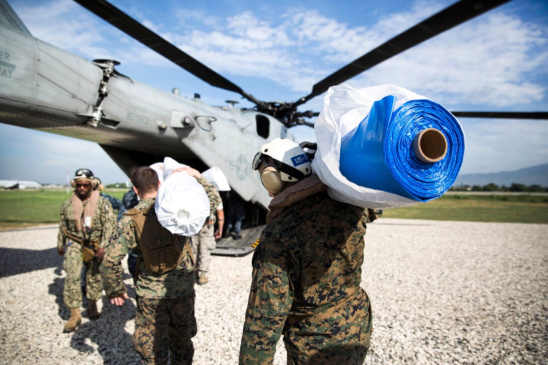 Marines load humanitarian supplies and equipment onto a CH-53 Super Stallion helicopter in Port-au-Prince, Haiti, Oct. 17, 2016. Marine Corps photo by Cpl. Brianna Gaudi