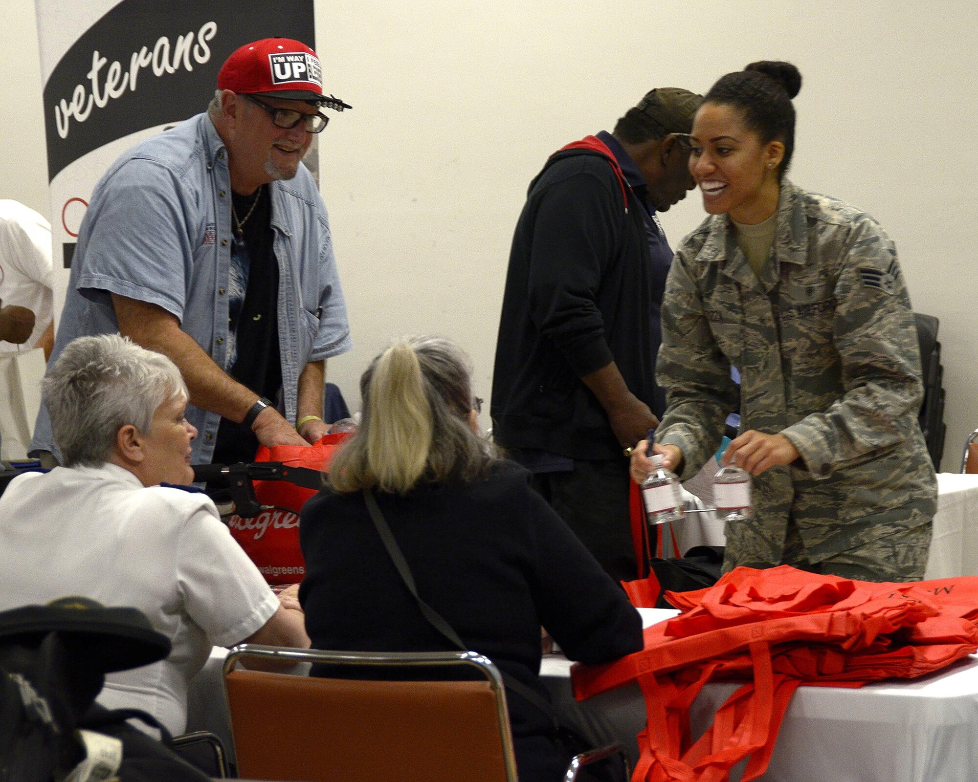 Senior Airman Adrienne Zizza, a medical technician with the 445th Aerospace Medicine Squadron, converses with a couple other volunteers at the Dayton Veterans Affairs Medical Center Homeless Vets Stand down event Sept. 30, 2016. Wing volunteers participated in the annual event that provides a meal, clothing, health screenings, VA and Social Security benefits counseling, and referrals to a variety of other necessary services, such as: housing, employment, substance abuse and mental health treatment services to more than 300 veterans. (U.S. Air Force photo/Staff Sgt. Joel McCullough)