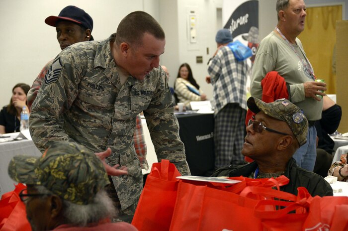 Master Sgt. Anthony Phillips 445th Civil Engineer Squadron operations management apprentice, distributes clothing items to a local vet during the Dayton Veterans Affairs Medical Center Homeless Vets Stand Down event Sept. 30, 2016. 445th Airlift Wing volunteers participated in the annual event that provides a meal, clothing, health screenings, VA and Social Security benefits counseling, and referrals to a variety of other necessary services, such as: housing, employment, substance abuse and mental health treatment services to more than 300 veterans. (U.S. Air Force photo/Staff Sgt. Joel McCullough)