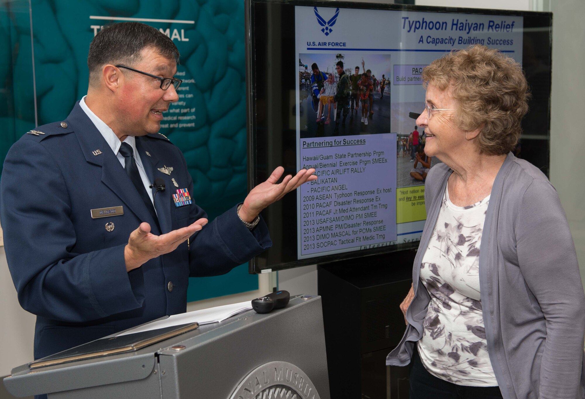 September 2016 Science Cafe.                            
U.S. Air Force Col. Antonio Jose Delgado, Medical Corps, speaks to a Medical Museum Science Café attendee following his talk. Col. Delgado, the interim director of the International Health Specialist Program at the Air Force Medical Support Agency, spoke about global health engagement at the National Museum of Health and Medicine on Tuesday, Sept. 27, 2016. (Disclosure: This image has been cropped to emphasize the subject.) (National Museum of Health and Medicine photo by Matthew Breitbart/ Released)
