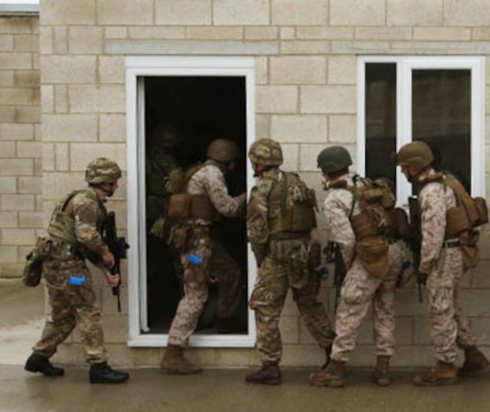 U.S. Marines and British Royal Commandos enter a building together in the first phase of security forces training in New Castle Upon Tyne, England, Sept. 21-25, 2015. Training included various breaching techniques, close-quarters battle, live-fire ranges, training simulators with various military and the state-of-the-art training facility in Gateshead with the Northumbria Police Department. The training evolution was designed to increase close quarters battle skills with one another. Experienced instructors kept a watchful eye on every movement and provided an in-depth critique of every decision made and what result it could have in a real-world situation.