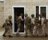 U.S. Marines and British Royal Commandos enter a building together in the first phase of security forces training in New Castle Upon Tyne, England, Sept. 21-25, 2015. Training included various breaching techniques, close-quarters battle, live-fire ranges, training simulators with various military and the state-of-the-art training facility in Gateshead with the Northumbria Police Department. The training evolution was designed to increase close quarters battle skills with one another. Experienced instructors kept a watchful eye on every movement and provided an in-depth critique of every decision made and what result it could have in a real-world situation.