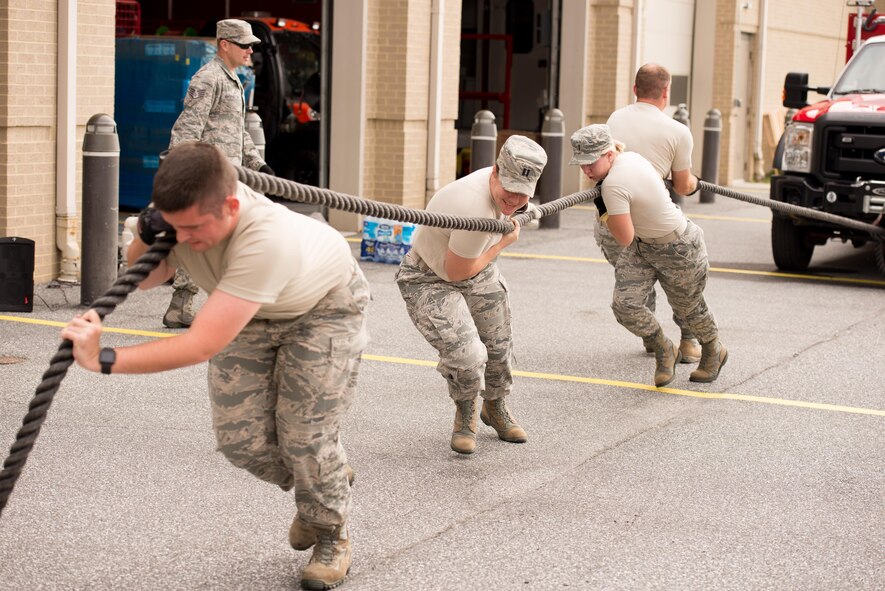 A team of officers from the 436th Civil Engineer Squadron pull an emergency vehicle during the 2016 Fire Muster competition Oct. 13, 2016, on Dover Air Force Base, Del. Four person teams attempted to pull the vehicle a distance of 80 feet as quick as possible. (U.S. Air Force photo by Mauricio Campino)
