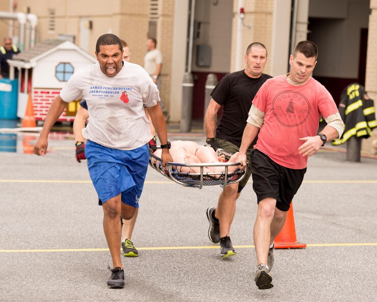 A team of Airmen from 436th Civil Engineer Squadron run while carrying a simulated casualty on a stretcher during the 2016 Fire Muster competition Oct. 13, 2016, on Dover Air Force Base, Del. Teams had to carry the stretcher with a training mannequin 100 feet. (U.S. Air Force photo by Mauricio Campino)