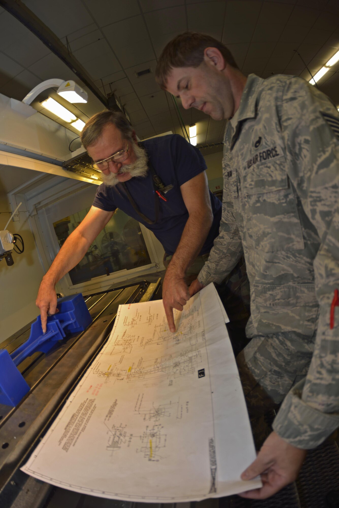 Mr. Gary Surozenski and Tech. Sgt. Richard Towlson check and re-check the measurements with the blue prints.