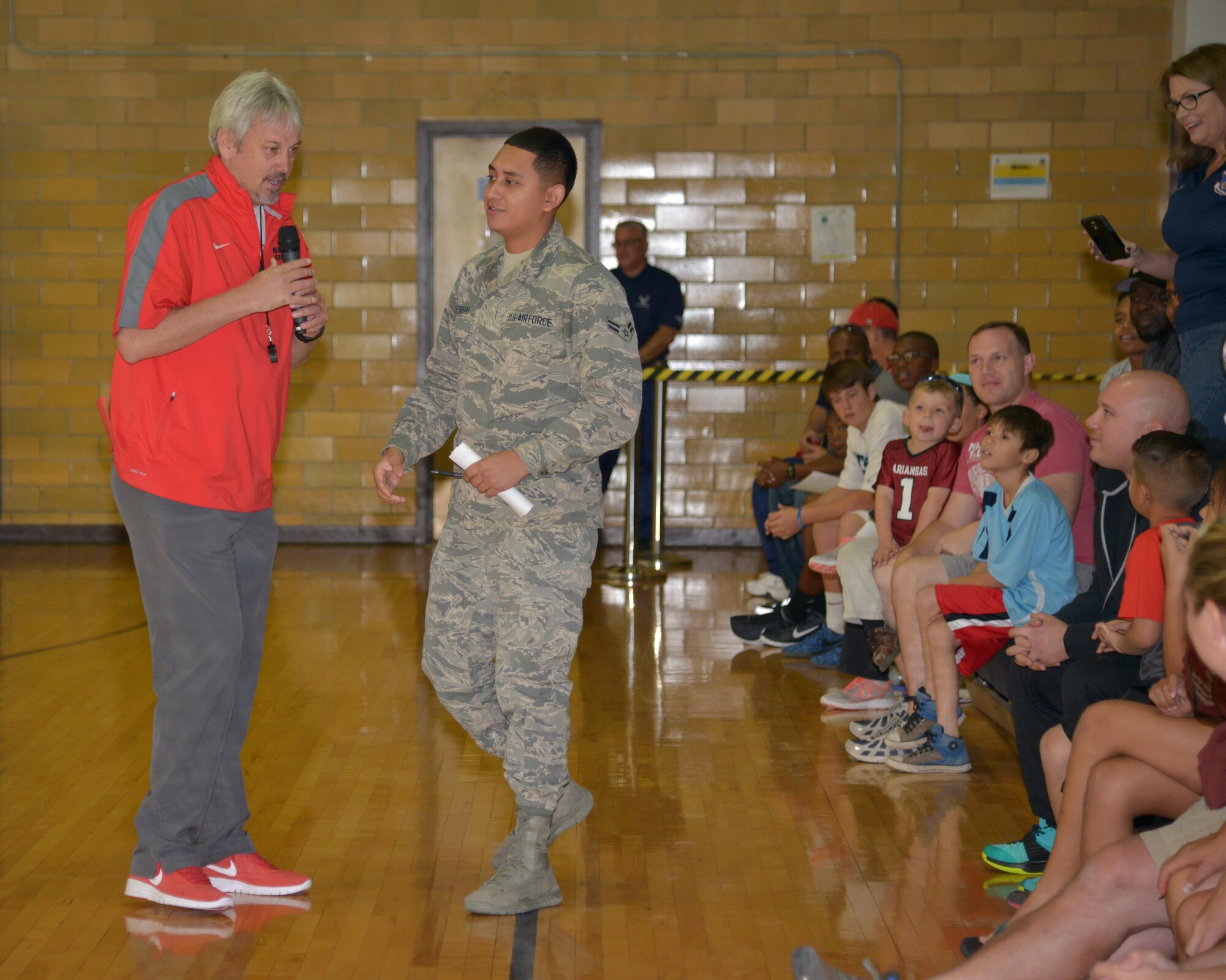 Airman 1st Class Abraham Guerrero was called out of the crowd by UNM Lobos men's basketball head coach Craig Neal following a scrimmage at the Kirtland East Fitness Center Oct. 15. Guerrero picked five players to shoot half court shots in an effort to win season tickets to the Lobos games. Although they all missed, Neal still awarded Guerrero with tickets. The scrimmage was scheduled on base to allow the team to show appreciation to military members.
