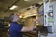 Mr. Gary Surozenski, a metal technician, in the 439th Maintenance Squadron, sets up the milling machine with the CAD data instructions to create the new C-5 elevator support bracket.