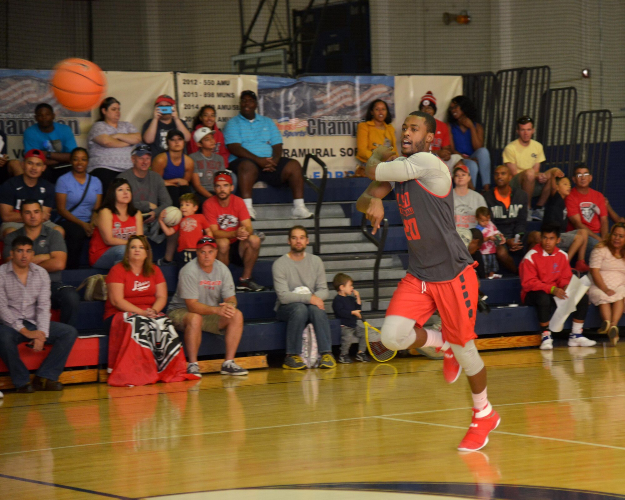 Lobos men's basketball player Sam Longwood passes the ball during a scrimmage at the Kirtland East Fitness Center Oct. 15. About 100 fans watched the practice, which was scheduled on base to allow the team to show appreciation to military members. 