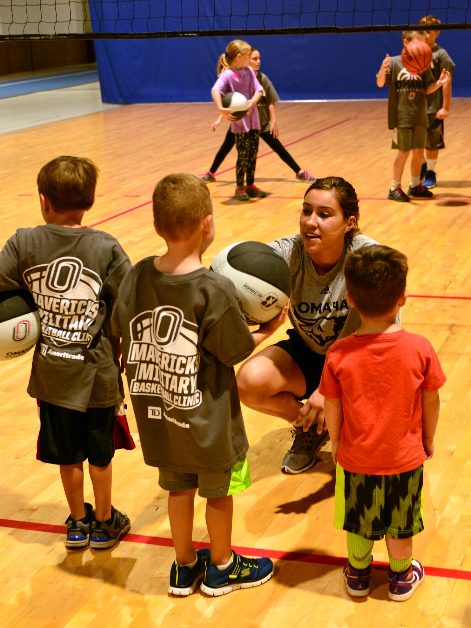 Abi Lujan, University of Nebraska Omaha senior, gives Team Offutt children ball-handling tips Oct. 15, 2016 at the Offutt Field House.  The UNO Mavericks’ men’s and women’s basketball teams provided a free basketball clinic to more than 100 military-affiliated children. Nebraska Governor Pete Ricketts spoke to the campers and passed along thanks from the citizens of Nebraska to the members of Team Offutt.