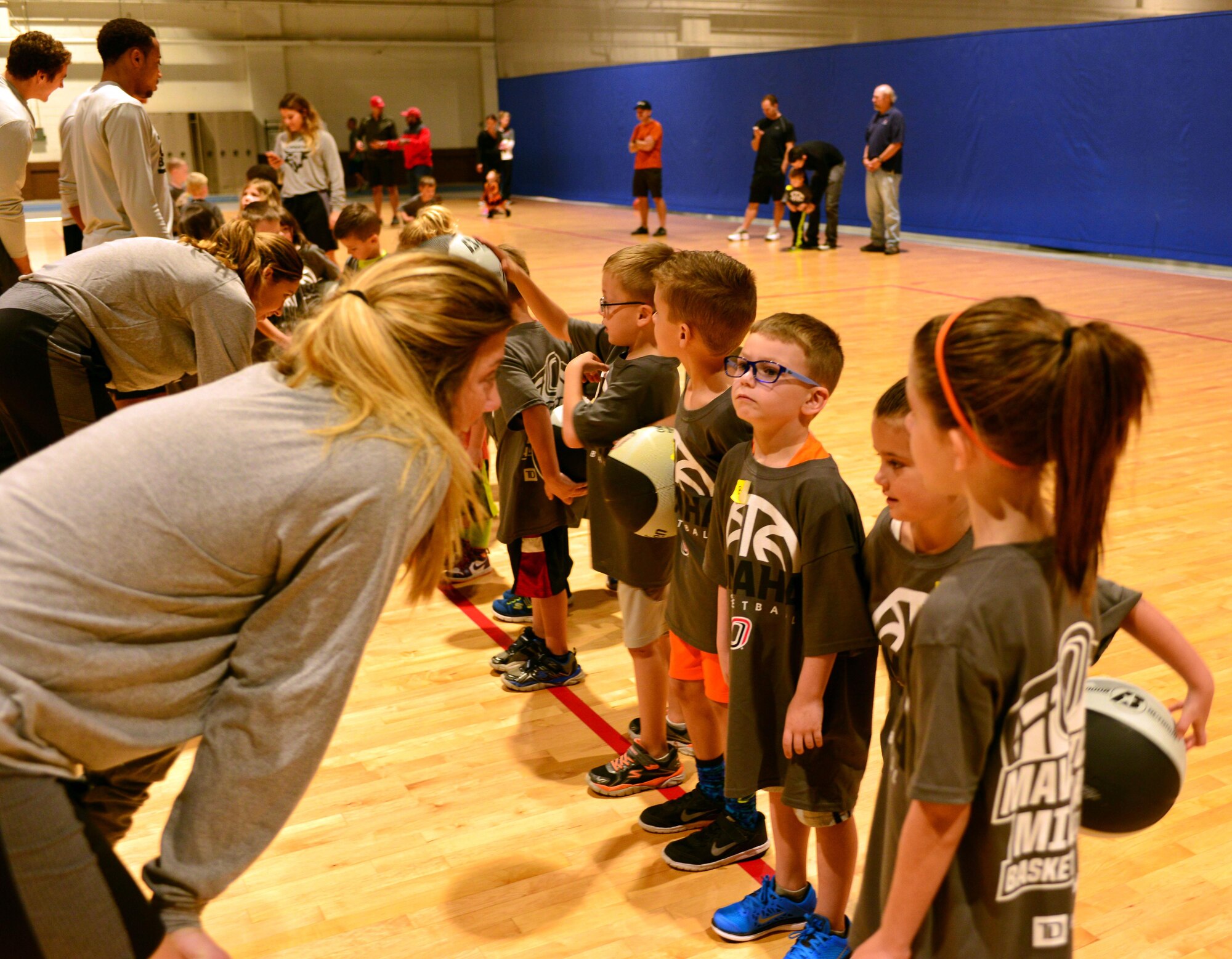 Ellie Brecht, University of Nebraska Omaha sophomore, motivates Team Offutt children to give it their all Oct. 15, 2016 at the Offutt Field House.  The UNO Mavericks’ men’s and women’s basketball teams provided a free basketball clinic to more than 100 military-affiliated children. Nebraska Governor Pete Ricketts spoke to the campers and passed along thanks from the citizens of Nebraska to the members of Team Offutt.