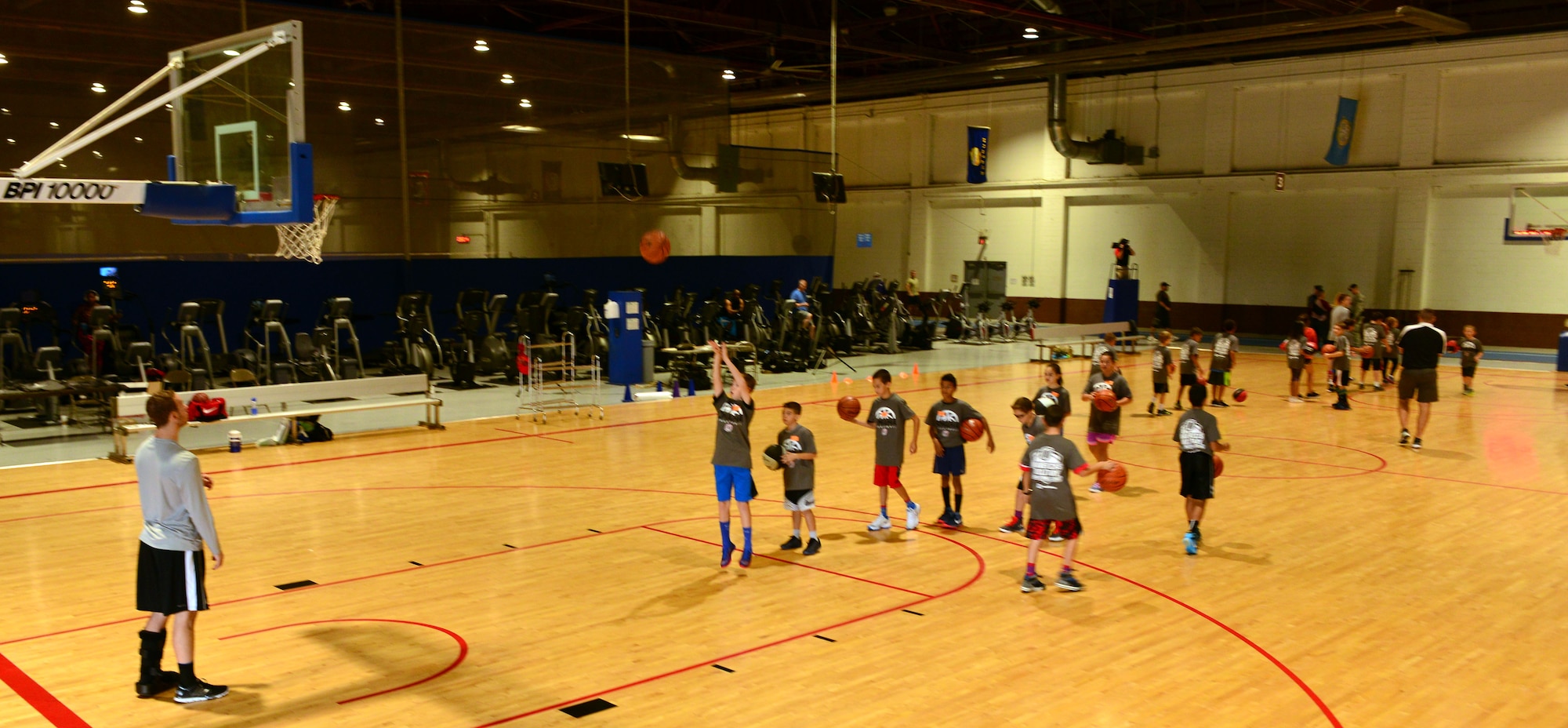 A Team Offutt child takes a jumper under the watchful eye of a University of Nebraska Omaha Mavericks player Oct. 15, 2016 at the Offutt Field House.  The UNO Mavericks’ men’s and women’s basketball teams provided a free basketball clinic to more than 100 military-affiliated children. Nebraska Governor Pete Ricketts spoke to the campers and passed along thanks from the citizens of Nebraska to the members of Team Offutt. 