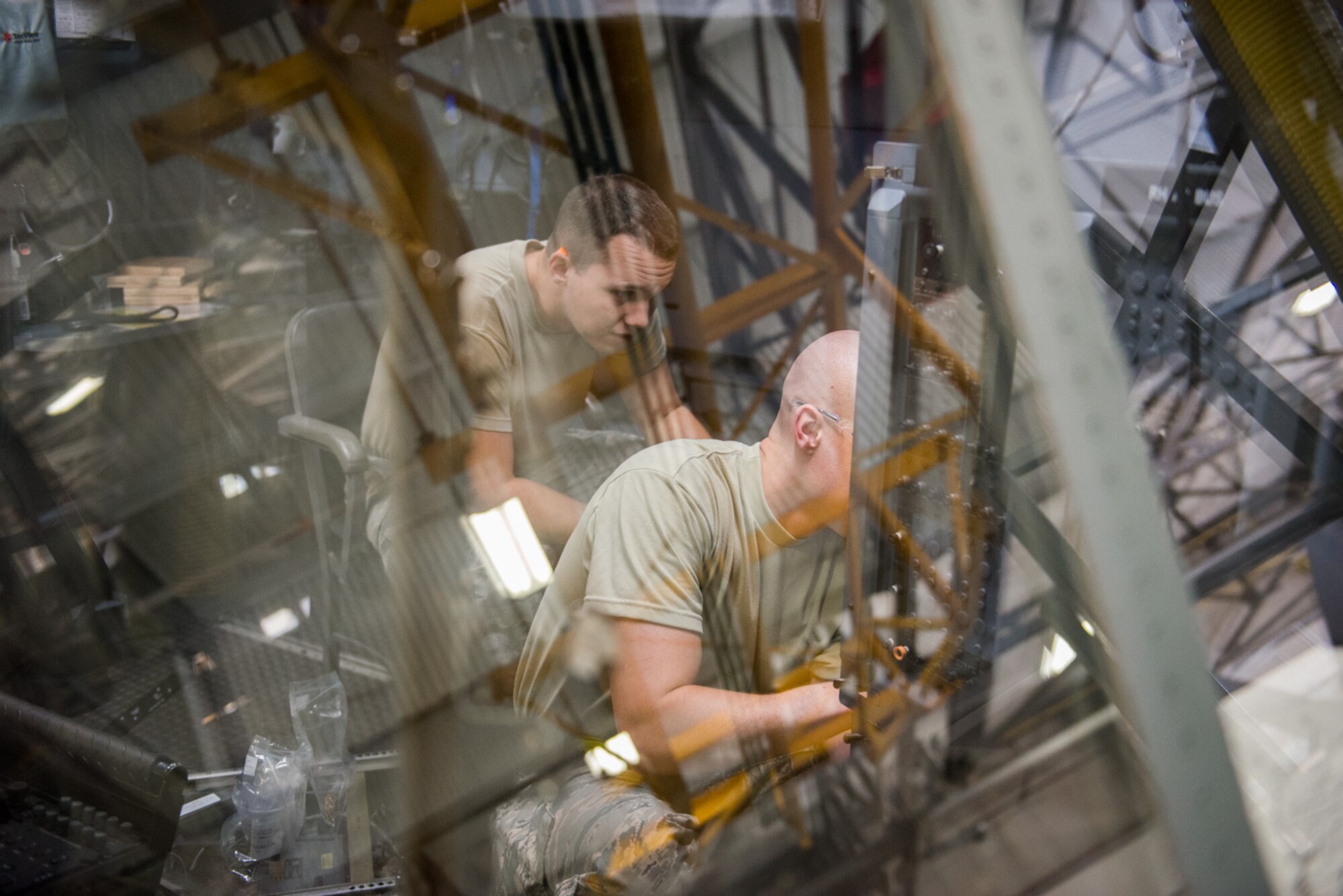 Staff Sgt. Trent Tufte, left, and Tech. Sgt. Robert Jessen, 934th Maintenance Squadron, perform routine pre-deployment maintenance on the flight deck of a C-130 October 16. (U.S. Air Force photo by Tech. Sgt. Trevor Saylor)