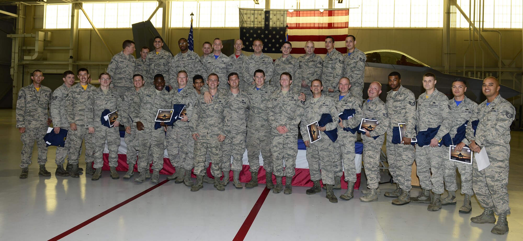 1st Fighter Wing Airmen celebrate after being inducted as dedicated crew chiefs at Joint Base Langley-Eustis, Va. Oct 14, 2016. Dedicated crew chiefs compete against each other through a series of evaluations and performance reviews to be assigned to a specific aircraft and have their name displayed on its side. (U.S. Air Force photo by Airman 1st Class Kaylee Dubois)
