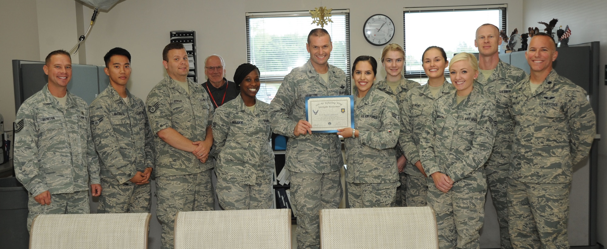 Senior Airman Maria Camunez, 22nd Aerospace Medical Squadron public health technician, poses with Col. Phil Heseltine, 22nd Air Refueling Wing vice commander, 22nd AMDS leadership and members of the 22nd AMDS public health section, Oct. 12, 2016, at McConnell Air Force Base, Kan. Camunez received the spotlight performer for the week of Sept. 26-30. (U.S. Air Force photo/Airman 1st Class Jenna K. Caldwell)