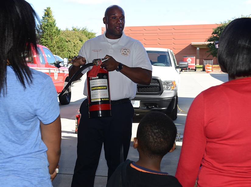 Keith Boyd, Fort Eustis Fire and Emergency Services assistant fire chief, explains the purpose and techniques for using a fire extinguisher during Fire Prevention Week at Joint Base Langley-Eustis, Va., Oct. 15, 2016. Fire Prevention Week is recognized each year during the second full week of October. (U.S. Air Force photo by Staff Sgt. Teresa  J. Cleveland)