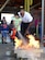 Keith Boyd, Fort Eustis Fire and Emergency Services assistant fire chief, cheers on Victoria, age 10, daughter of U.S. Army Staff Sgt. Terrance Haggard, 2nd Staff and Faculty, U.S. Army Transportation School instructor, as she puts out a fire during Fire Prevention Week at Joint Base Langley-Eustis, Va., Oct. 15, 2016. Children were given the opportunity to extinguish a fire, while supervised by firefighters, to understand how to properly use an extinguisher. (U.S. Air Force photo by Staff Sgt. Teresa  J. Cleveland)