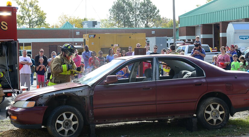 Members of the Fort Eustis Fire and Emergency Services break through the windshield of a car during Fire Prevention Week at Joint Base Langley-Eustis, Va., Oct. 15, 2016. Firefighters used this technique to demonstrate rescuing trapped individuals from a vehicle accident. (U.S. Air Force photo by Staff Sgt. Teresa  J. Cleveland)