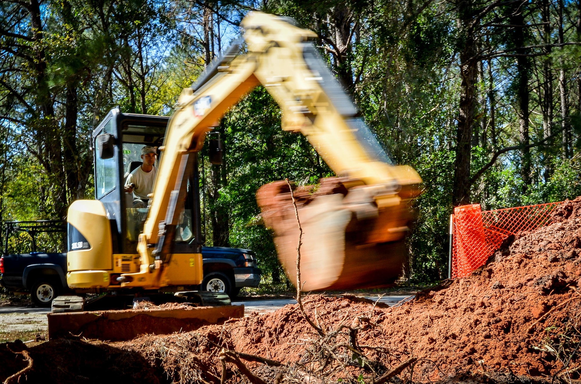 U.S. Air Force Staff Sgt. Justin Waters, 20th Civil Engineer Squadron pavement and construction equipment journeyman, clears dirt from around a broken water pipe at Shaw Air Force Base, S.C., Oct. 13, 2016. Heavy equipment operators were needed to clear the dirt and debris so water and fuels technicians could fix the water pipe. (U.S. Air Force photo by Senior Airman Diana M. Cossaboom)