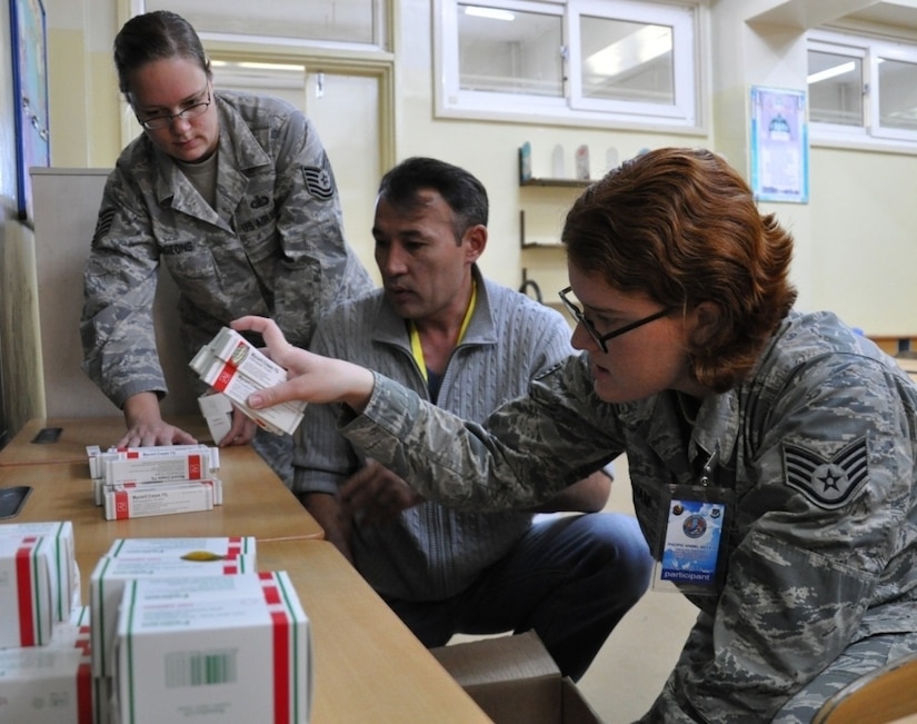 From left, Air Force Tech. Sgt. Maria Hudgeons, assigned to the 22nd Comptroller Squadron; a Mongolian translator; and Air Force Staff Sgt. Nadine Statham, assigned to the 354th Medical Support Squadron; count pharmaceuticals in preparation for a health services outreach site in Erdenet, Mongolia, during Pacific Angel-Mongolia 14-4, Aug. 13, 2014. Pacific Angel is a joint and combined humanitarian assistance operation conducted in the Pacific area of responsibility to support U.S. Pacific Command's capacity-building efforts. Air Force photo by Capt. Justin Billot