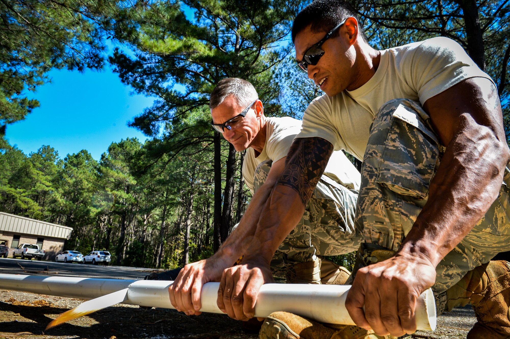 U.S. Air Force Col. Daniel Lasica, 20th Fighter Wing commander, cuts a PVC replacement pipe with Staff Sgt. Clayton Bautista, 20th Civil Engineer Squadron water and fuels systems craftsman, to fix a broken water pipe at Shaw Air Force Base, S.C., Oct. 13, 2016. To repair the water pipe, 20th CES Airmen located the origin of the break, shut the water valve, made the repairs and checked their repair by turning the water valve on slowly to ensure no leaks were present. (U.S. Air Force photo by Senior Airman Diana M. Cossaboom)