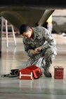 Airman 1st Class Matise Venett, 5th Aircraft Maintenance Squadron load crew member, gathers tools during a load crew of the quarter competition at Minot Air Force Base, N.D., Oct. 14, 2016. Two weapons load crews, representing the 23rd and 69th Bomb Squadrons, were timed on their ability to load an inert munition onto a B-52H Stratofortress. (U.S. Air Force photo/Senior Airman Kristoffer Kaubisch)
