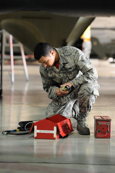 Airman 1st Class Matise Venett, 5th Aircraft Maintenance Squadron load crew member, gathers tools during a load crew of the quarter competition at Minot Air Force Base, N.D., Oct. 14, 2016. Two weapons load crews, representing the 23rd and 69th Bomb Squadrons, were timed on their ability to load an inert munition onto a B-52H Stratofortress. (U.S. Air Force photo/Senior Airman Kristoffer Kaubisch)