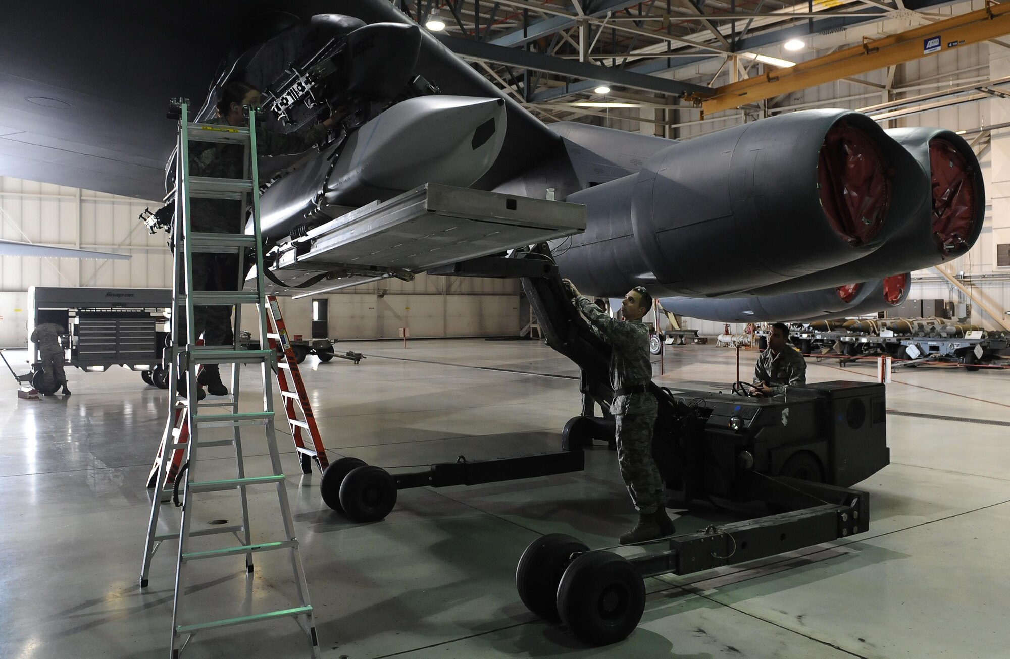 Airmen from the 5th Aircraft Maintenance Squadron use a MHU-83 Jammer to load an inert munition during the load crew of the quarter competition at Minot Air Force Base, N.D., Oct. 14, 2016. Two weapons load crews, representing the 23rd and 69th Bomb Squadrons, were timed on their ability to load an inert munition onto the buff. (U.S. Air Force photo/Senior Airman Kristoffer Kaubisch)