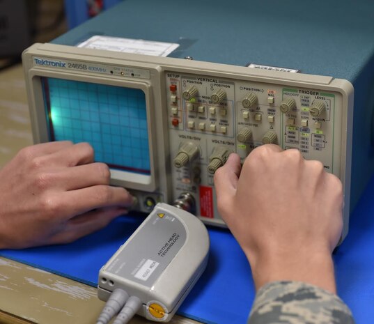 Airman 1st Class William Matlock, 437th Maintenance Squadron electronics technician, adjusts a Tektronix 2465b oscilloscope on Oct. 4, 2016, at Joint Base Charleston, South Carolina. Oscilloscopes compare a plot of voltage versus time to measure electronic frequencies and power such as those used in radio communication.