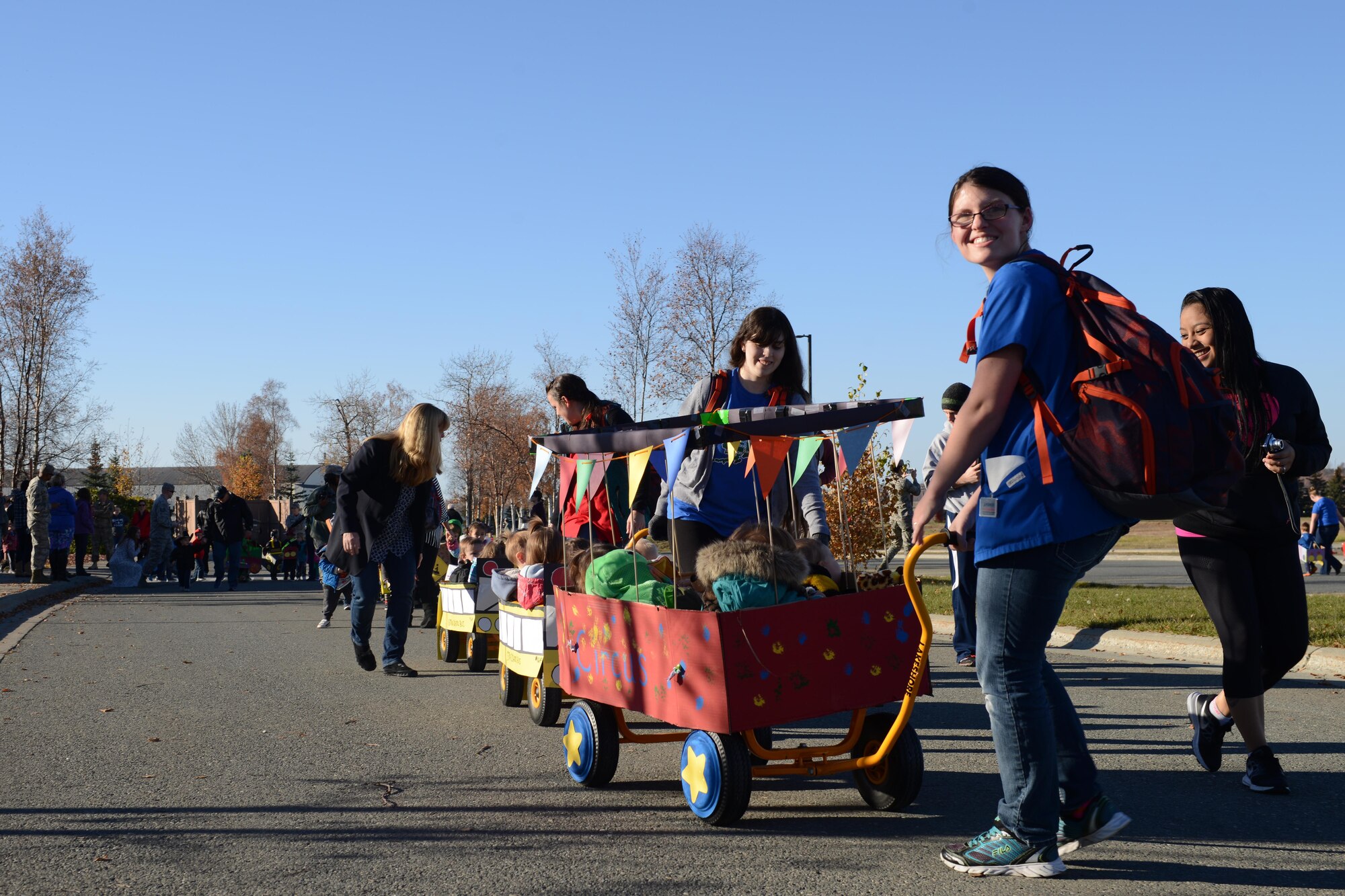 Sitka Child Development Center members and staff roll their parade floats at the Transportation Parade at the Sitka CDC parking lot at Joint Base Elmendorf-Richardson, Alaska, Oct. 14, 2016. October is transportation month at Sitka CDC. Floats in the parade highlight different types of transportation. All floats were built at home to encourage parental participation. 