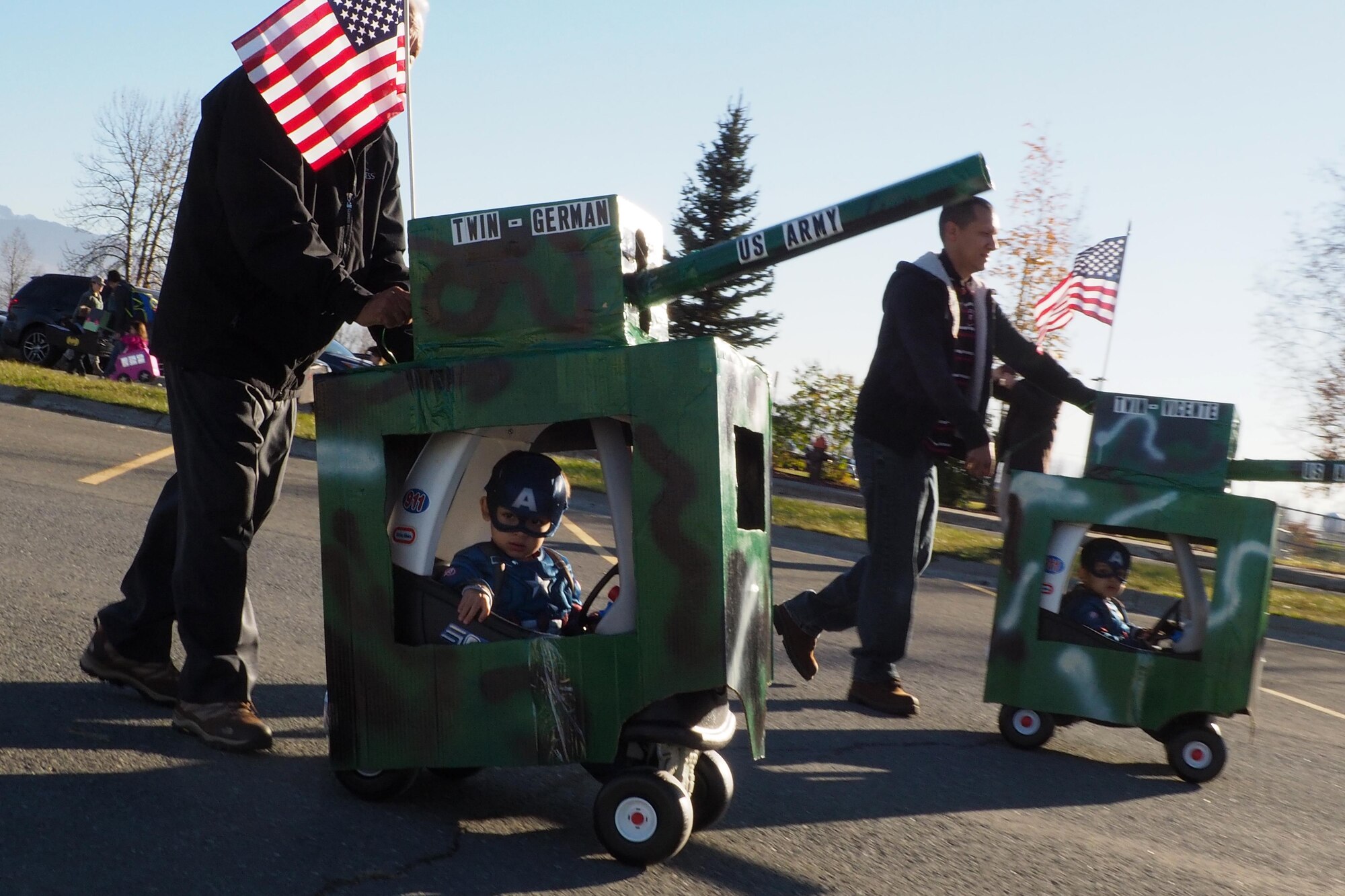 Vincent, 2, and German Gutierrez De Pineres, 2, roll past during the Transportation Parade at the Sitka parking lot at Joint Base Elmendorf-Richardson, Alaska, Oct. 14, 2016. October is transportation month at Sitka CDC. Floats in the parade highlight different types of transportation. All floats were built at home to encourage parental participation. 