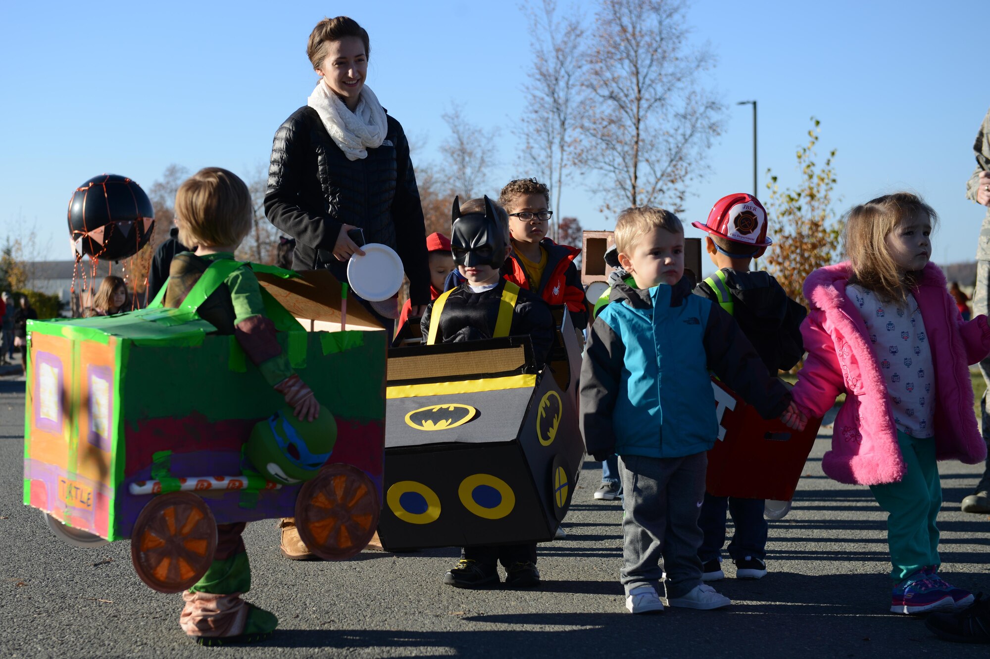 Sitka Child Development Center members and staff show off their parade floats at the Transportation Parade at the Sitka CDC parking lot at Joint Base Elmendorf-Richardson, Alaska, Oct. 14, 2016. October is transportation month at Sitka CDC. Floats in the parade highlight different types of transportation. All floats were built at home to encourage parental participation. 