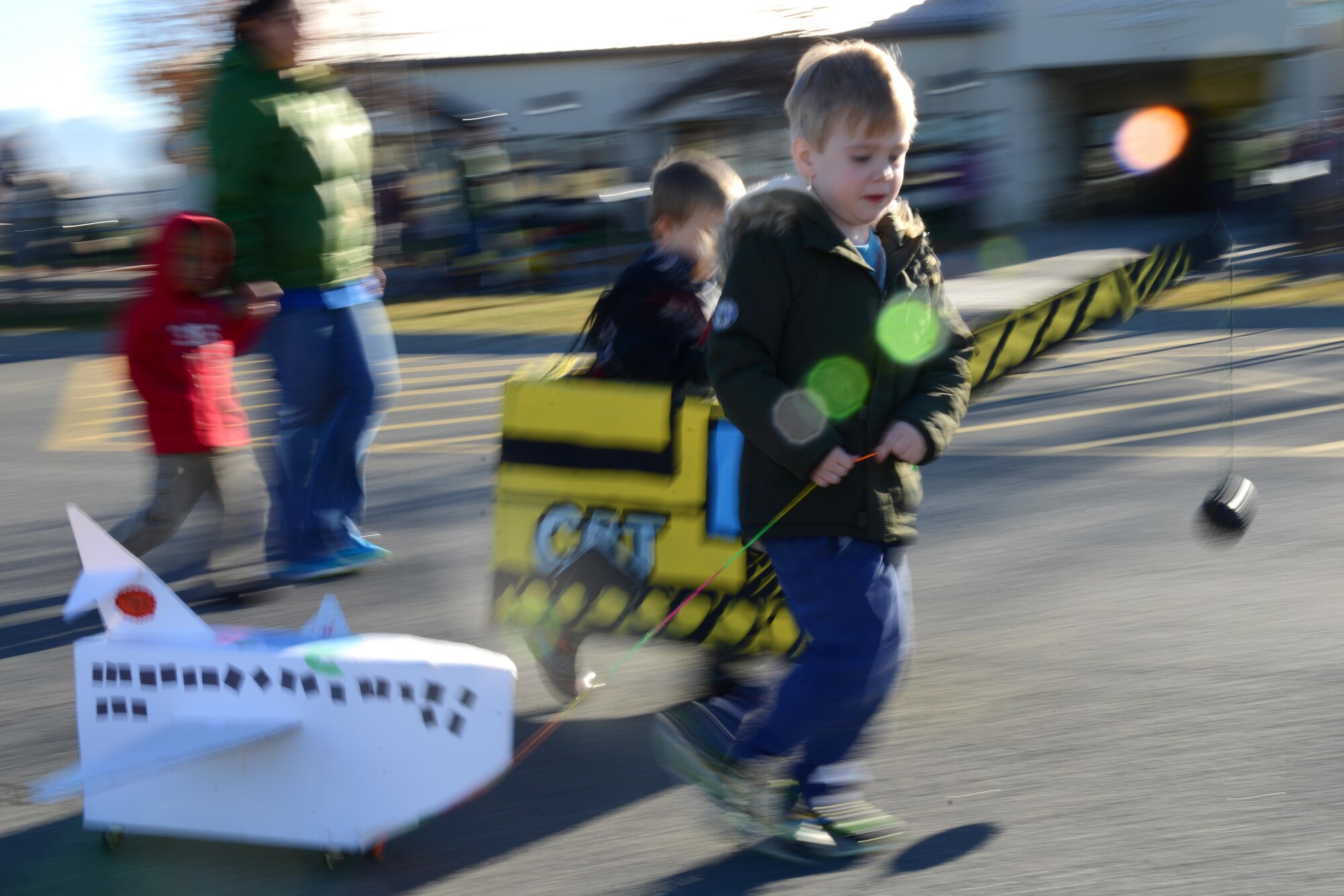 Toby Diggins, 4, pulls a plane during the Transportation Parade at the Sitka Child Development Center parking lot at Joint Base Elmendorf-Richardson, Alaska, Oct. 14, 2016. October is transportation month at Sitka CDC. Floats in the parade highlight different types of transportation. All floats were built at home to encourage parental participation. 